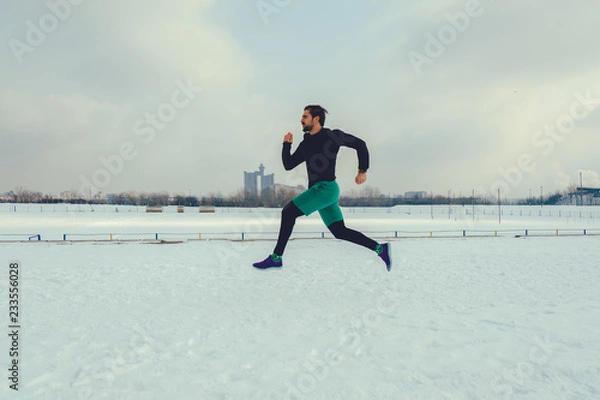 Obraz Bearded runner running on snow
