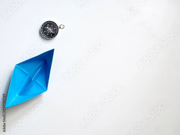 Obraz Blue paper boat with compass