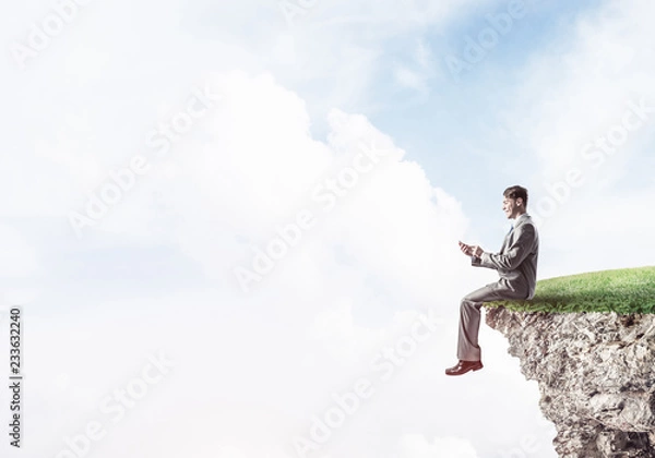 Fototapeta Businessman in suit with smartphone in hands send message