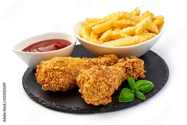 Fototapeta Deep Fried Breaded Chicken Legs (drumsticks) with tomato sauce and french fries, isolated on white background. Close-up.