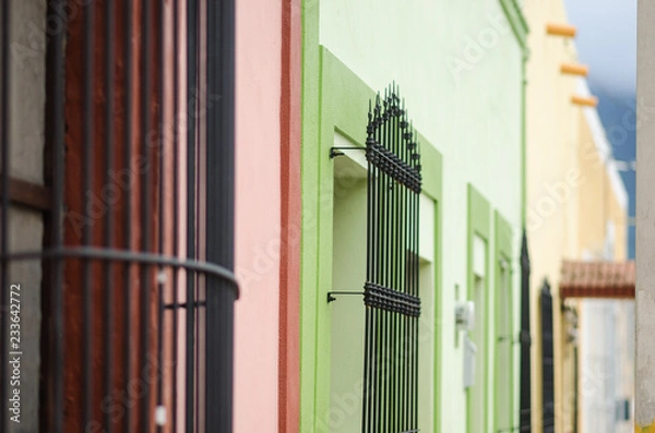 Fototapeta group of colorful windows in perspective with rusty bars, space for text