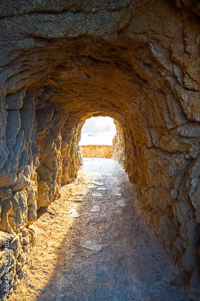 Fototapeta Tunnel in mountain with access to sea