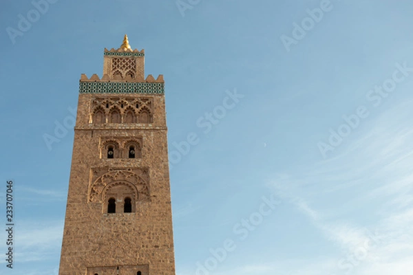 Fototapeta Koutoubia Mosque minaret (Djemma el Fna tower) in old medina of Marrakech, Morocco. Touristic place in Marrakesh used by local people as square or market place. 