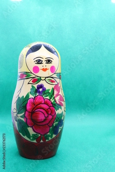 Fototapeta Russian doll against green background with copy space