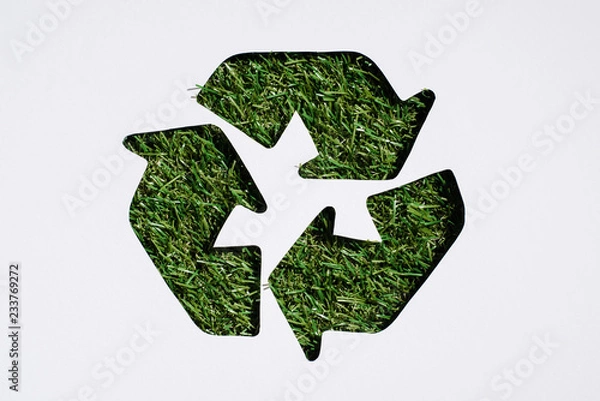 Fototapeta Top view of recycle sign with grass patern isolated on white