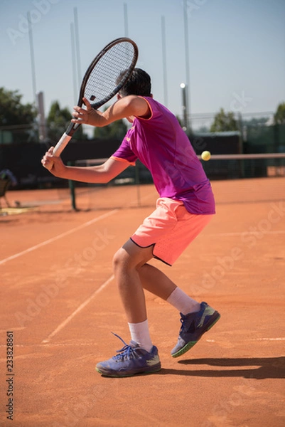Obraz Young tennis player playing backhand