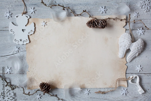 Fototapeta Christmas greeting, background, letter on a wooden background. Branches, bumps, angel wings and snowflakes.