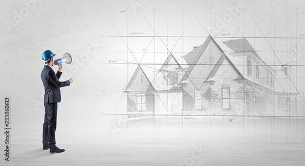 Fototapeta Architect standing and watching an imagined house plan

