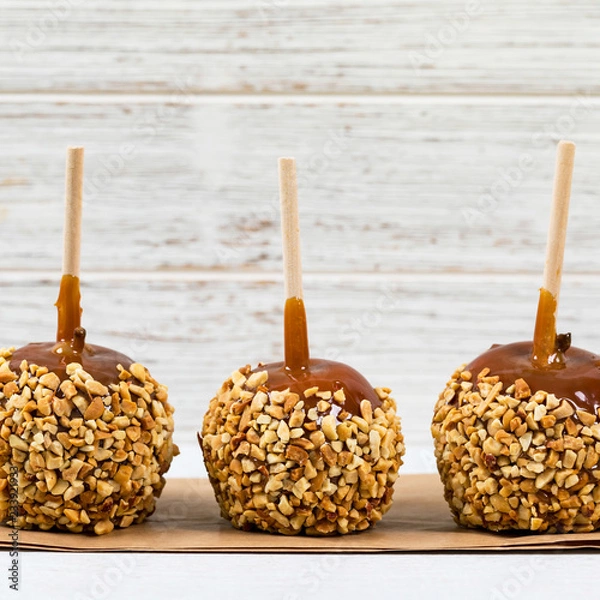 Fototapeta Caramel Apples on Wooden Background. Selective focus.