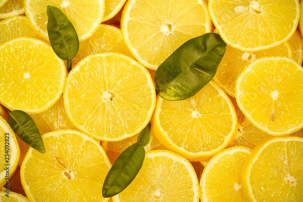 Obraz лимоны лежат дольки лежат на столе фоновое изображение 