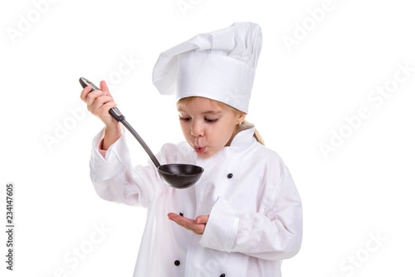 Obraz Girl chef white uniform isolated on white background. Holding black ladle and blowing to it. Looking at the ladle. Landscape image