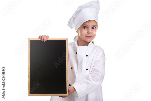 Obraz Cute girl chef white uniform isolated on white background. Girl with a floured face holding a menu black empty board. Landscape image