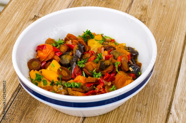 Fototapeta Ragout of vegetables in bowl on wooden table
