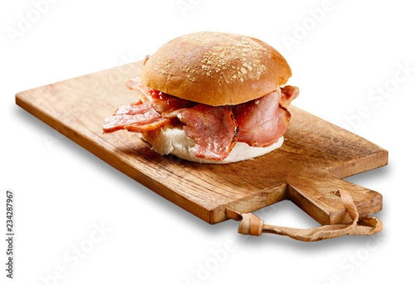 Fototapeta Bacon roll on a wooden board.
