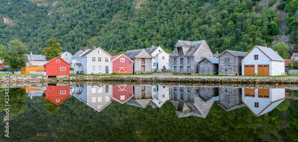 Fototapeta The old town of Gamla Lærdalsøyri is reflected in a calm and clear lake - a typical village in Norway.