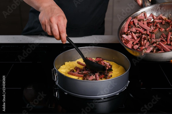 Obraz Chef puting fried lamb jerkey on polenta