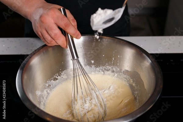 Obraz Chef adding flour and stirring