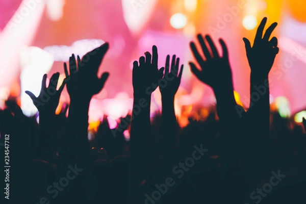 Obraz Hands silhouettes of the crowd raised up at colorful music show