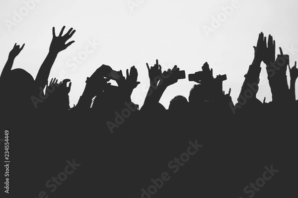 Obraz Hands silhouettes of the crowd raised up at music show. Black and white picture