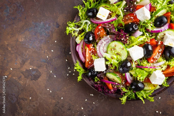 Fototapeta Greek salad with fresh vegetables and feta cheese