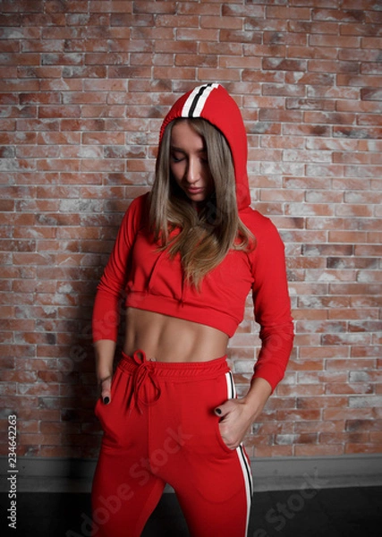 Obraz A portrait of nice beautiful girl is in a red suit