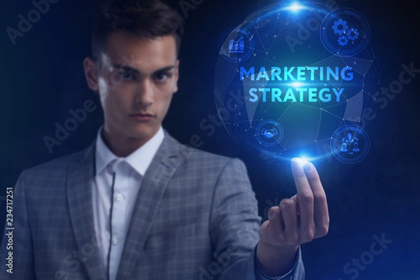 Fototapeta The concept of business, technology, the Internet and the network. A young entrepreneur working on a virtual screen of the future and sees the inscription: marketing strategy