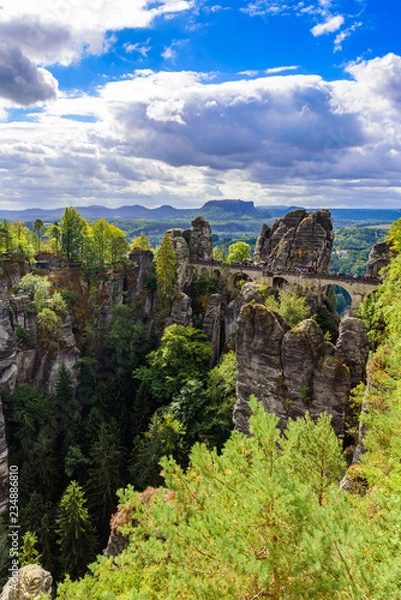 Fototapeta Panorama view on the Bastei bridge. Bastei is famous for the beautiful rock formation in Saxon Switzerland National Park, near Dresden and Rathen - Germany. Popular travel destination in Saxony.