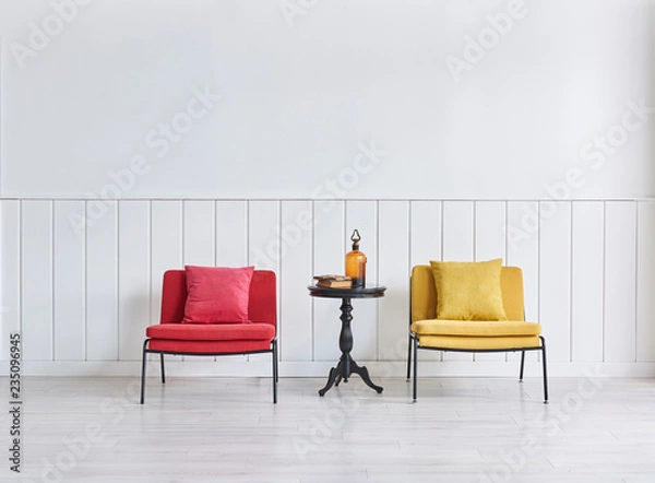 Fototapeta Red and yellow chair black coffee table and white wall.