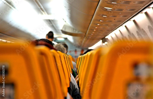Fototapeta Ryanair Jet airplanes interior between the seats view. Ryanair is the biggest low-cost airline company in the world. 