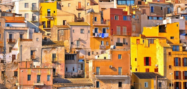 Fototapeta The colorful old houses with windows in city of Sciacca overlooking its harbour. Province of Agrigento, Sicily.