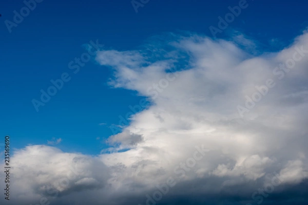 Obraz Clouds moving across the blue sky