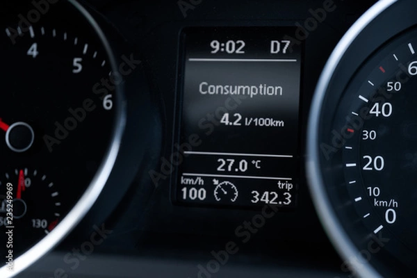 Obraz A Modern Car odometer Cluster with LCD Multifunction Display. Meter at constant speed show the fuel consumption efficiency 