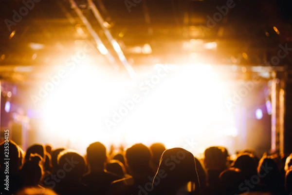 Obraz Crowd at the concert beside the stage in a bright warm stage lights