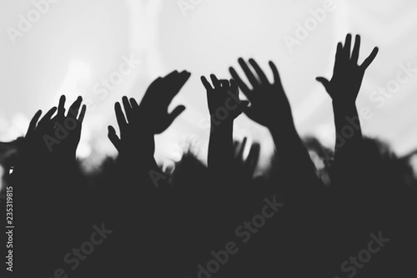 Obraz Hands silhouettes of the crowd raised up at music show. Black and white picture