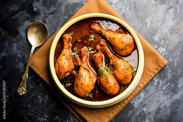 Obraz Chicken leg / drumstick curry or Murg Tangri/tangdi masala. Served in a bowl over moody background. Selective focus