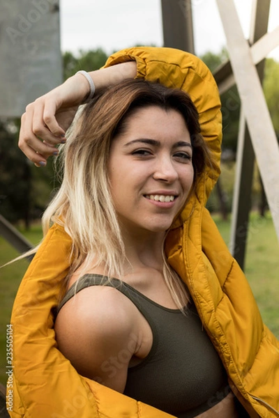 Fototapeta pretty young girl with a smile in the field in autumn