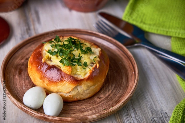Fototapeta Bread bowls stuffed with mushrooms, chicken meat, cheese and bolognese sauce for lunch. Julienne in a bun, creative burger idea