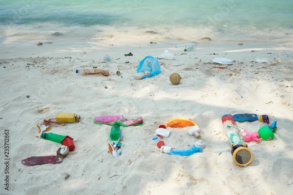 Fototapeta The Word Stop Written With Washed Up Plastic Debris On A White Beach In The Maldives. Ecological Message To The World.
