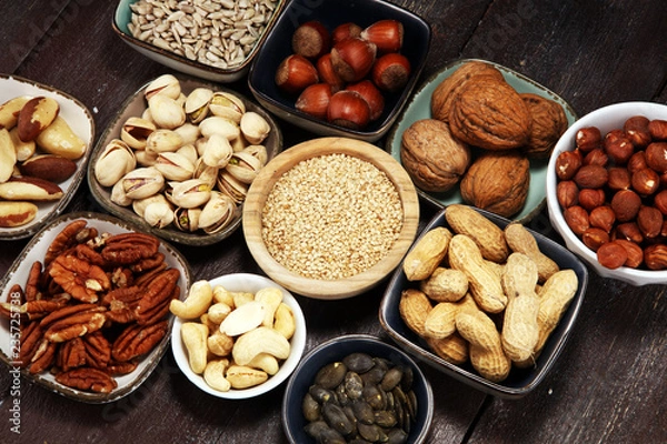 Fototapeta nuts composition on rustic table with walnut and peanut.
