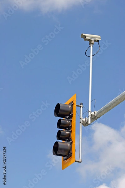 Obraz Security camera with traffic light and blue sky background.