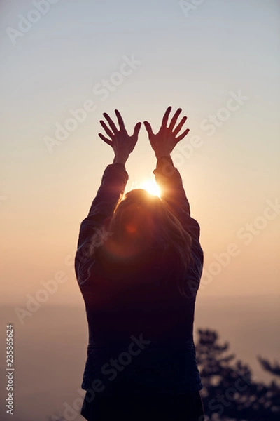 Obraz Woman with arms wide open enjoying the sunrise / sunset time.