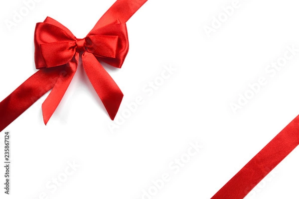 Obraz Shiny red satin ribbon on white background