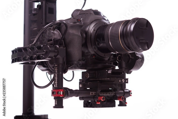 Fototapeta System stabilization video camera and lens on steady equipment support such as gimbal steady or stabilized. White background