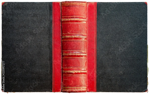 Fototapeta Old open book cover with black textured paper boards and cracked embossed red leather spine with abstract golden geometric decorations - circa 1864 - isolated on white