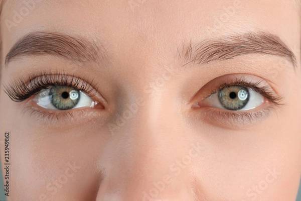 Fototapeta Young woman with beautiful eyelashes, closeup. Before and after extension procedure