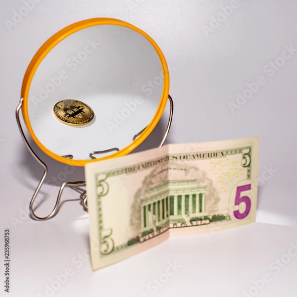 Fototapeta five dollar bill is reflected in the mirror.
