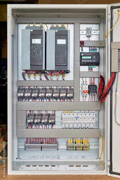 Obraz Electrical Cabinet with frequency converters, controller, circuit breaker. On the mounting panel mounted thermostat, intermediate relays and fuse holders. The wires are laid in cable channels.