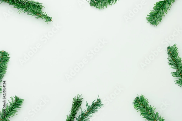 Fototapeta Table top view of Merry Christmas decorations & Happy new year ornaments concept.Flat lay essential difference objects green fir tree on modern rustic white paper background at home office desk.