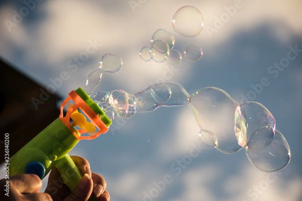 Fototapeta Image of toy gun shooting bubbles