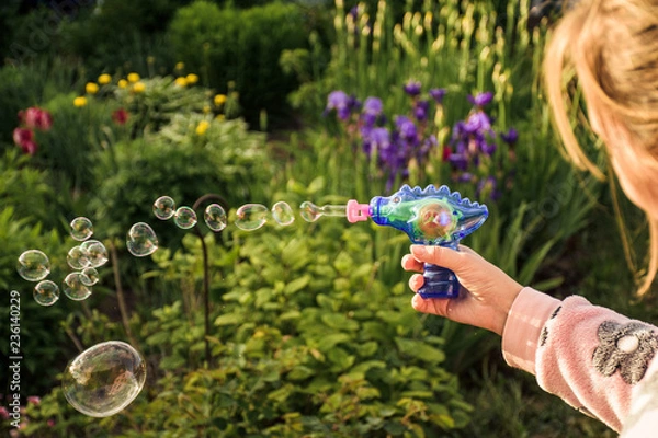 Fototapeta Image of toy gun shooting bubbles